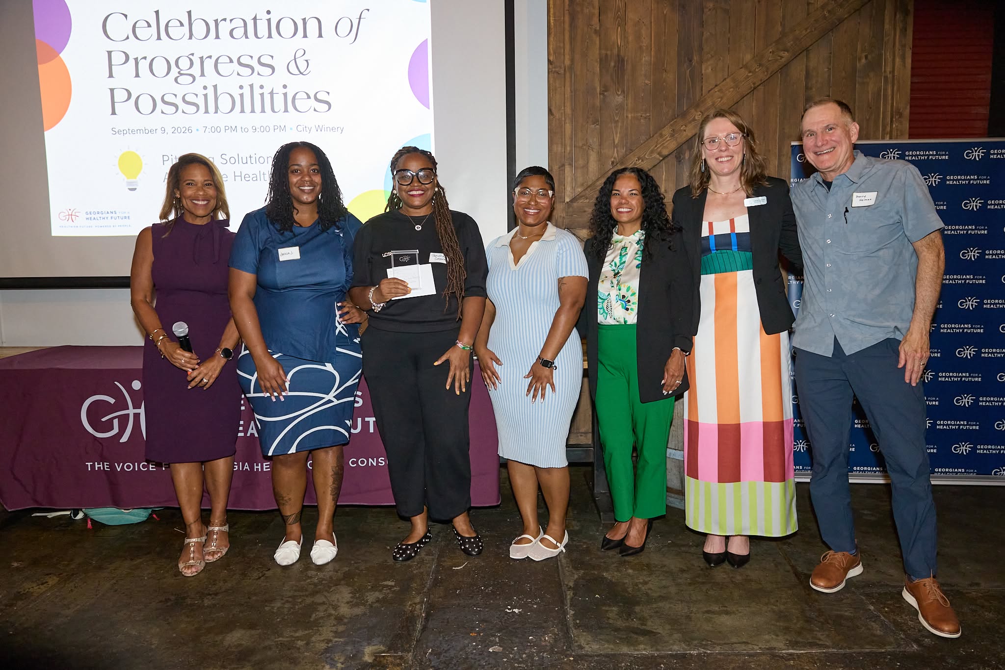 Tanisha Corporal, Jalisa Jordan, and Malika Thomas of Be Well, Black Girl Initiative accept the Most Innovative Idea award alongside judges and GHF staff.