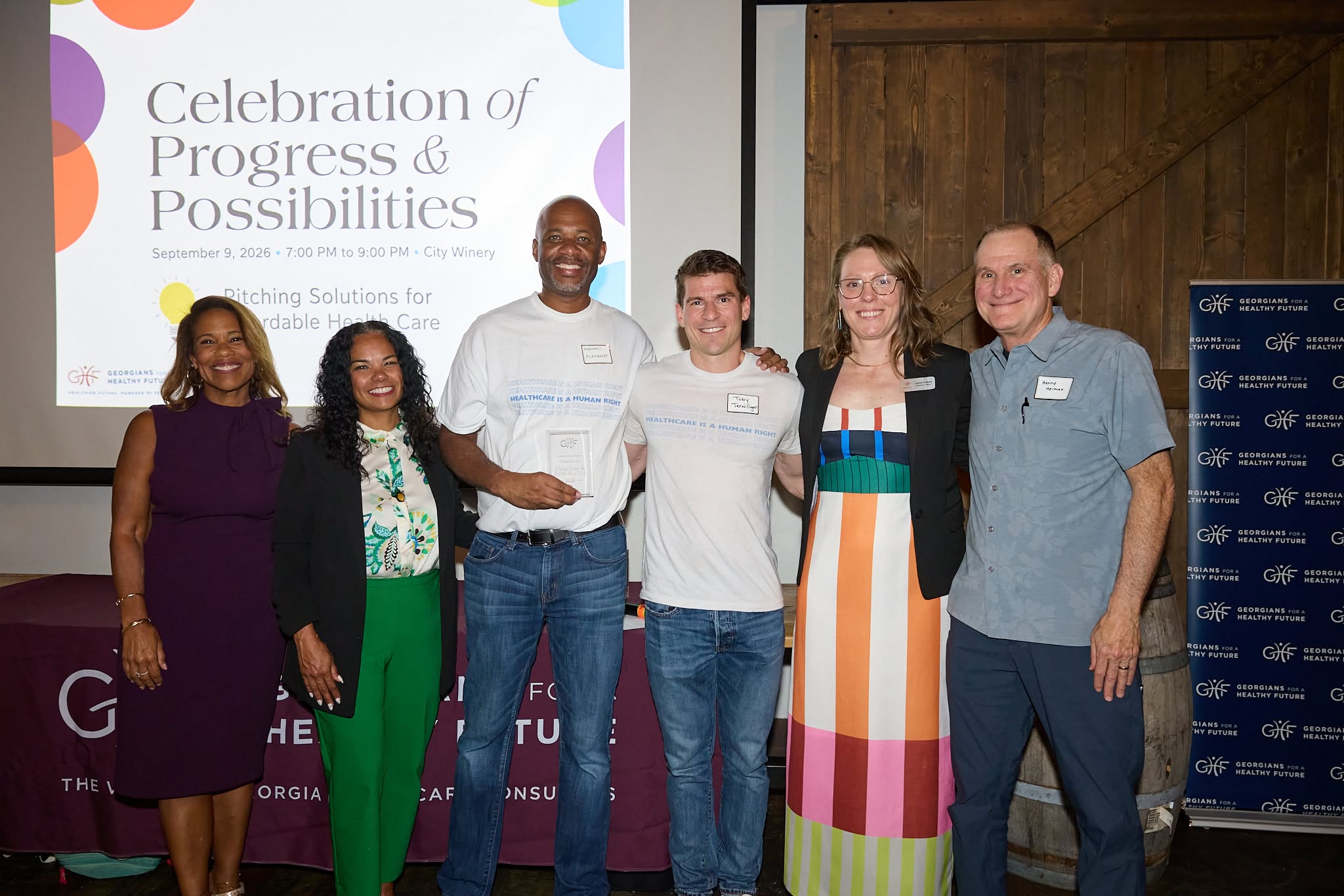 Marshall Fleurant and Toby Terwilliger of Georgians for a Universal Health Program accept the Greatest Potential Impact award alongside judges and GHF staff.