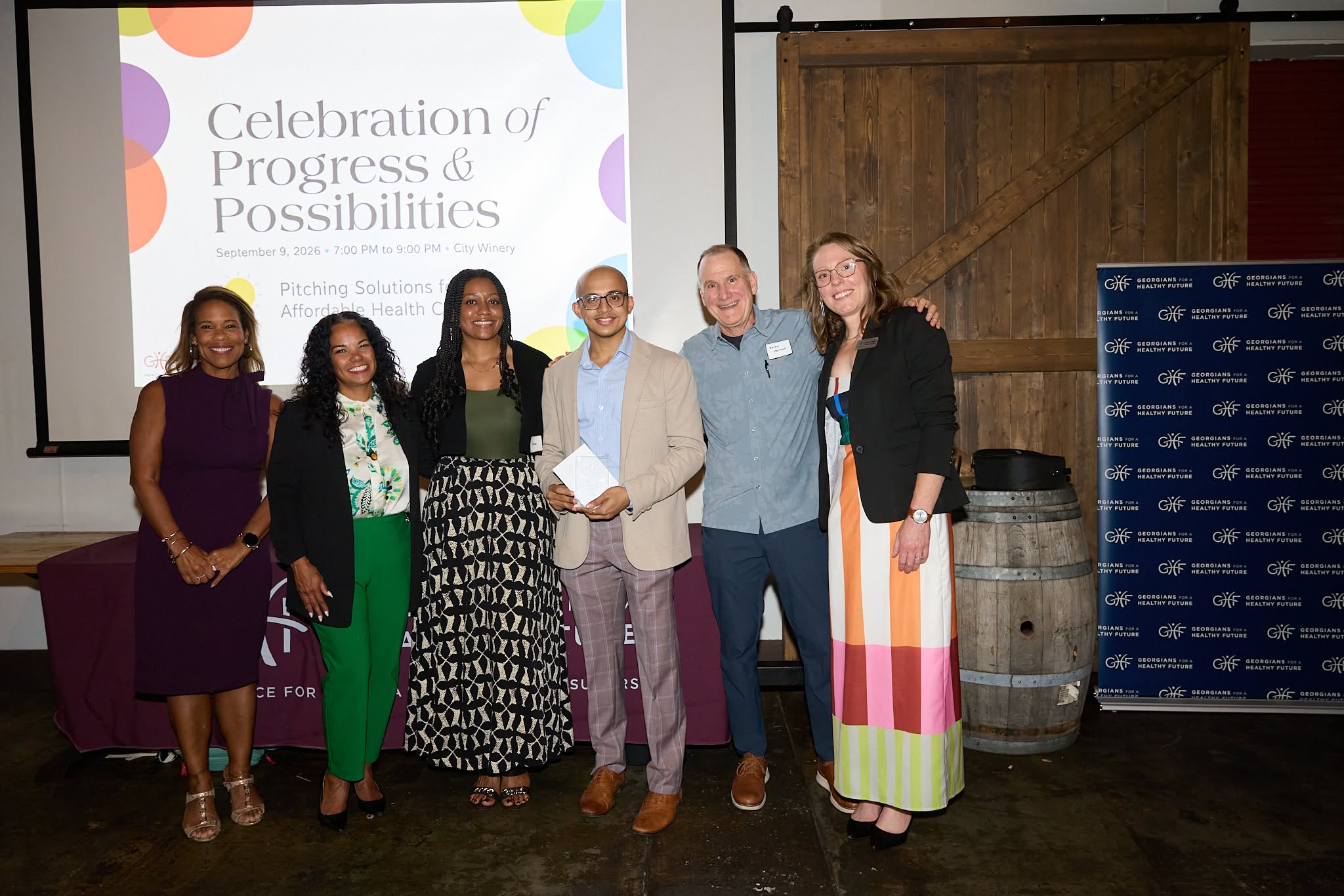 Hridith Sudev of H-STAT accepts the Most Actionable Solution award alongside judges and GHF staff.