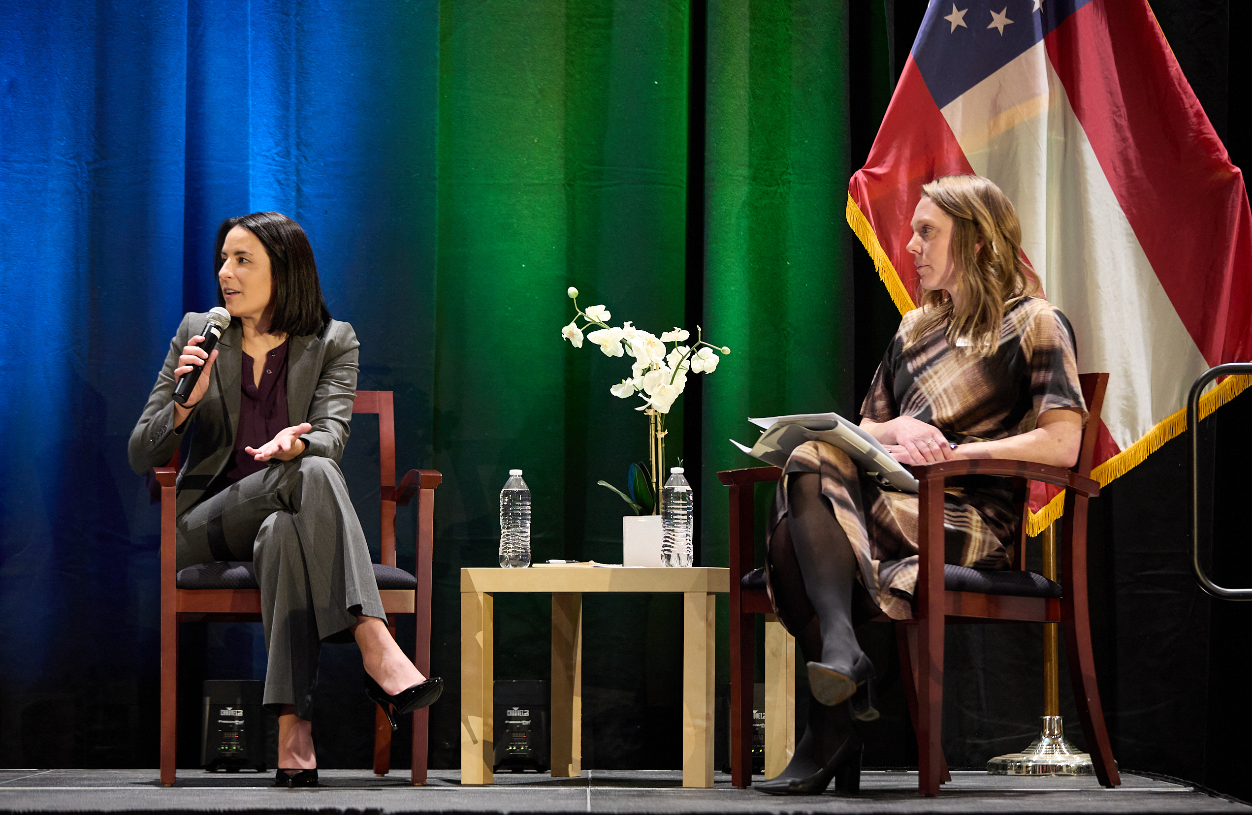 Two panelists in conversation on stage at Health Care Unscrambled