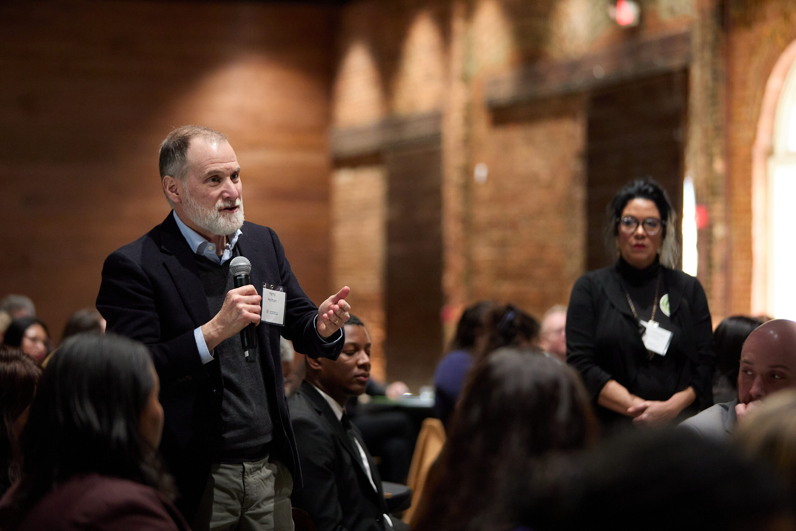 An attendee speaking during audience Q&A at Health Care Unscrambled