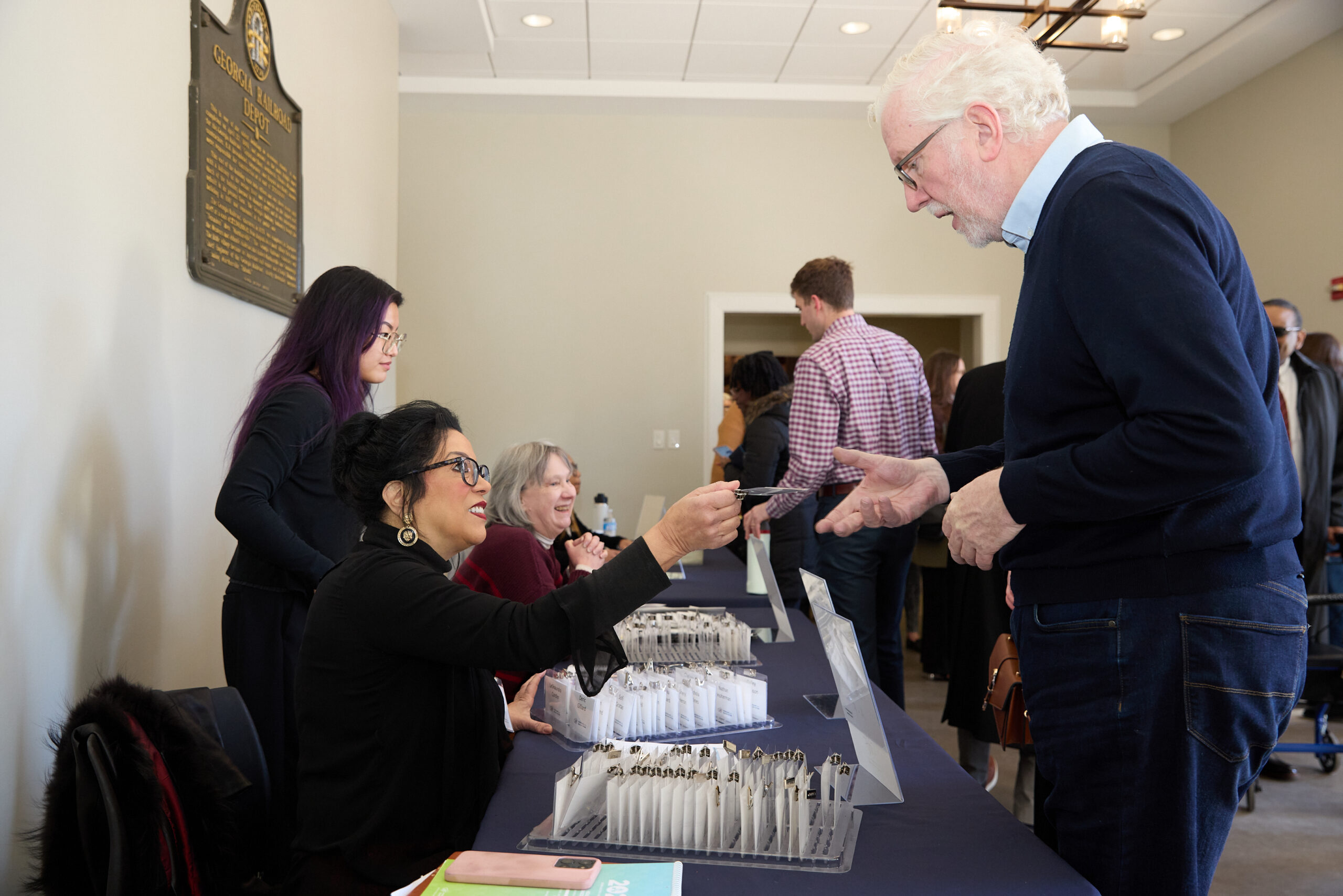 Attendees checking in and picking up name badges at Health Care Unscrambled