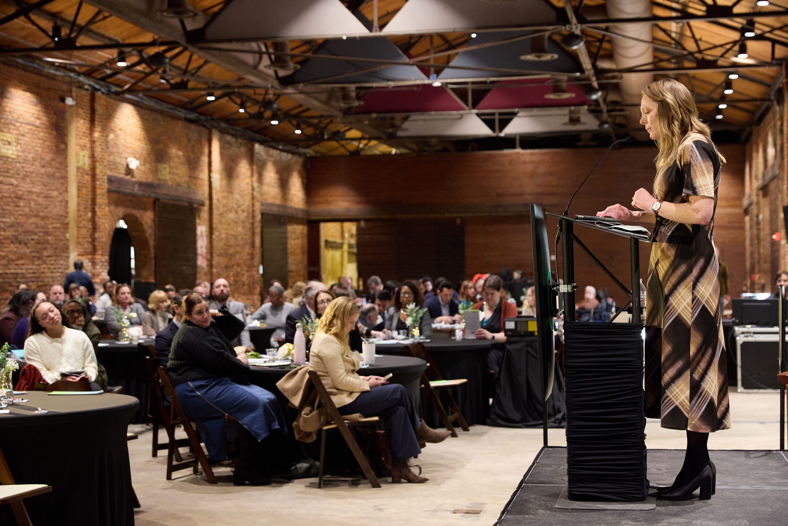 A speaker addressing a full room of attendees at Health Care Unscrambled, Georgia Freight Depot