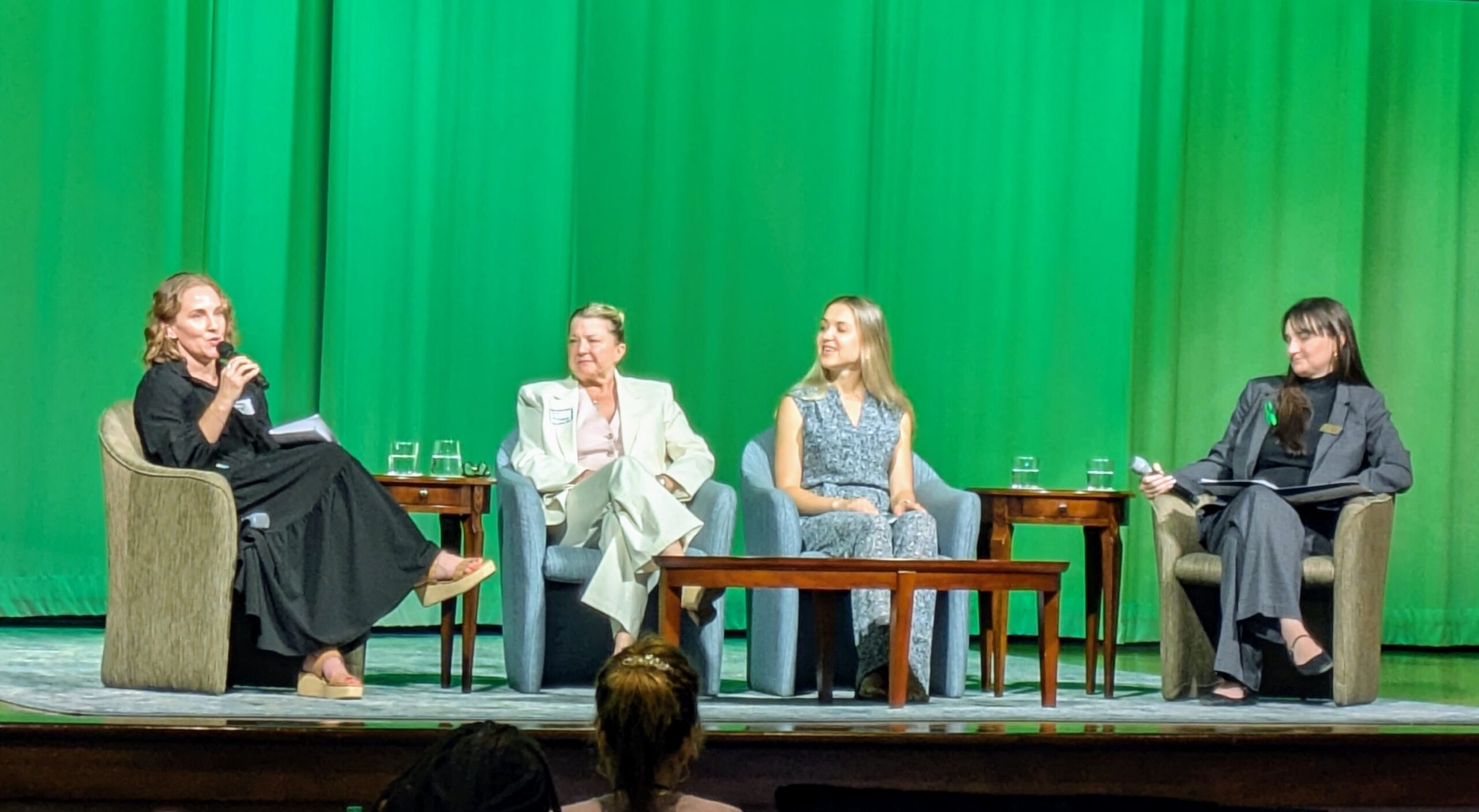 A panel discussion on stage at a mental health forum